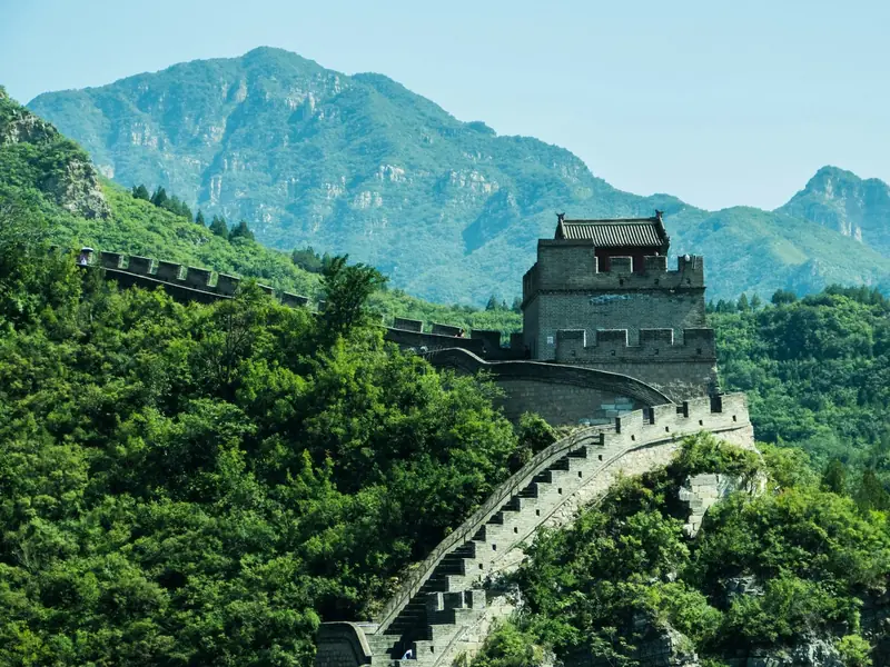 The Great Wall winding across green mountains